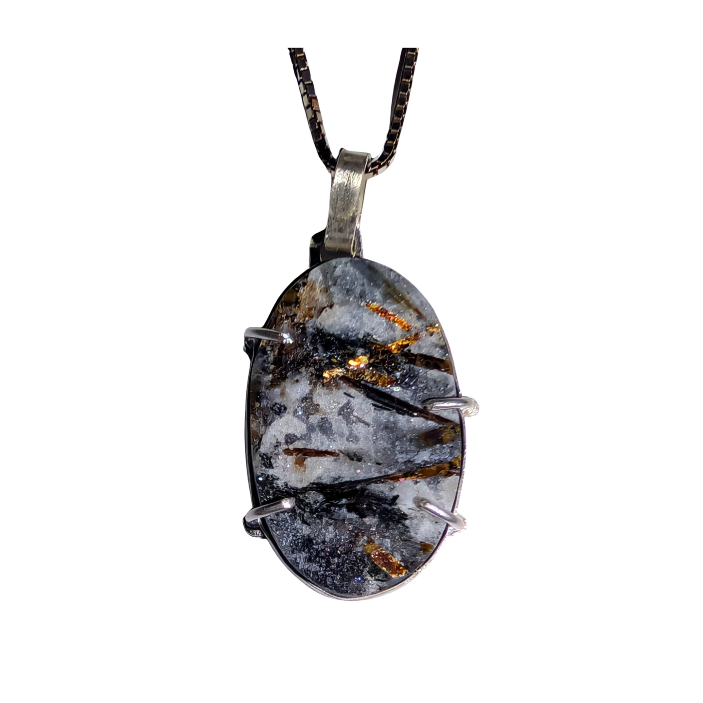 An oval pendant necklace featuring a dark gray and white marbled stone with metallic gold and copper inclusions, held in a silver-toned metal bezel and suspended from a black chain.