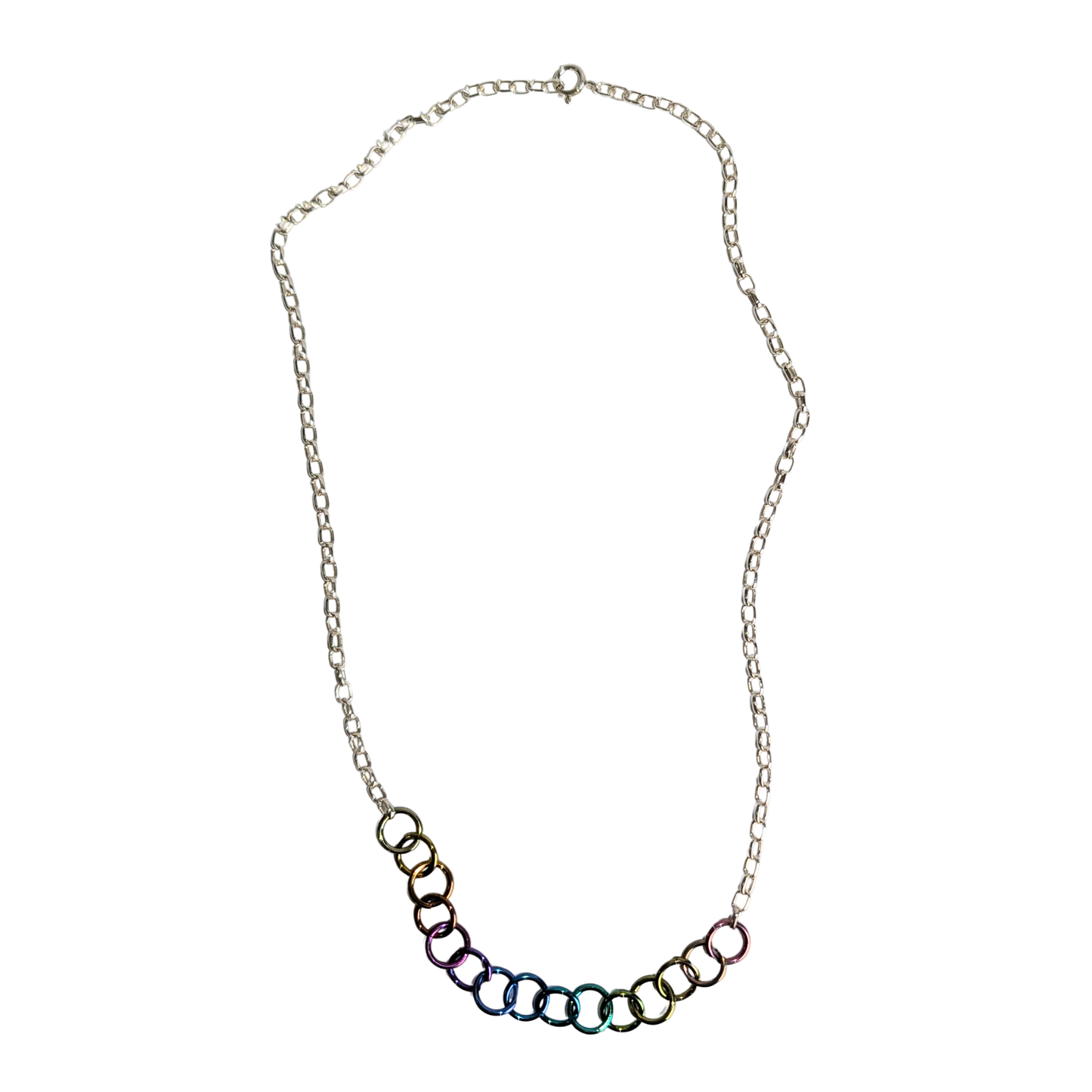 A silver chain necklace featuring a curved row of interlocking rings at the bottom, each with a different iridescent color finish, set against a plain white background.