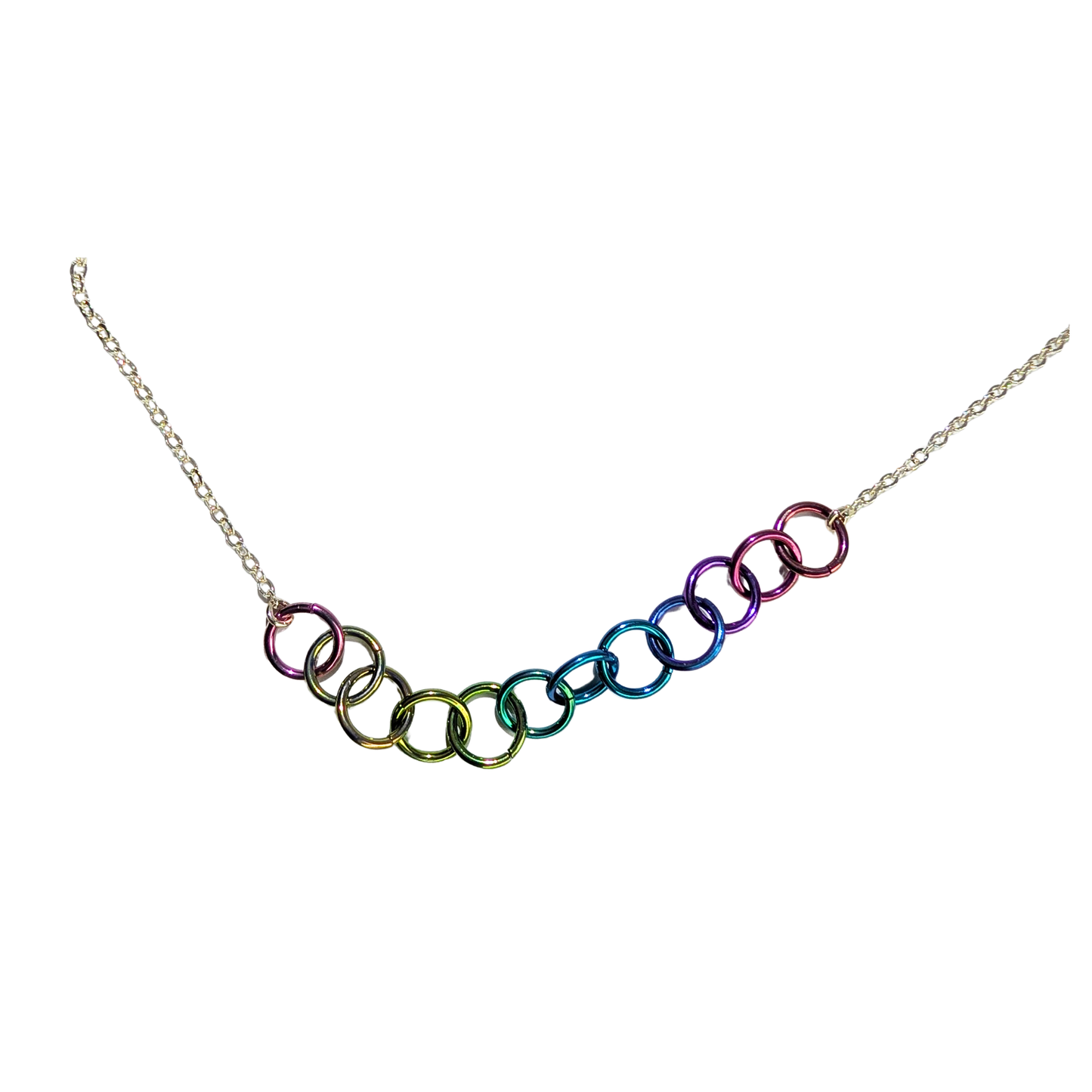 A silver chain necklace featuring a series of interlocking open rings in a rainbow gradient, photographed against a solid white background.